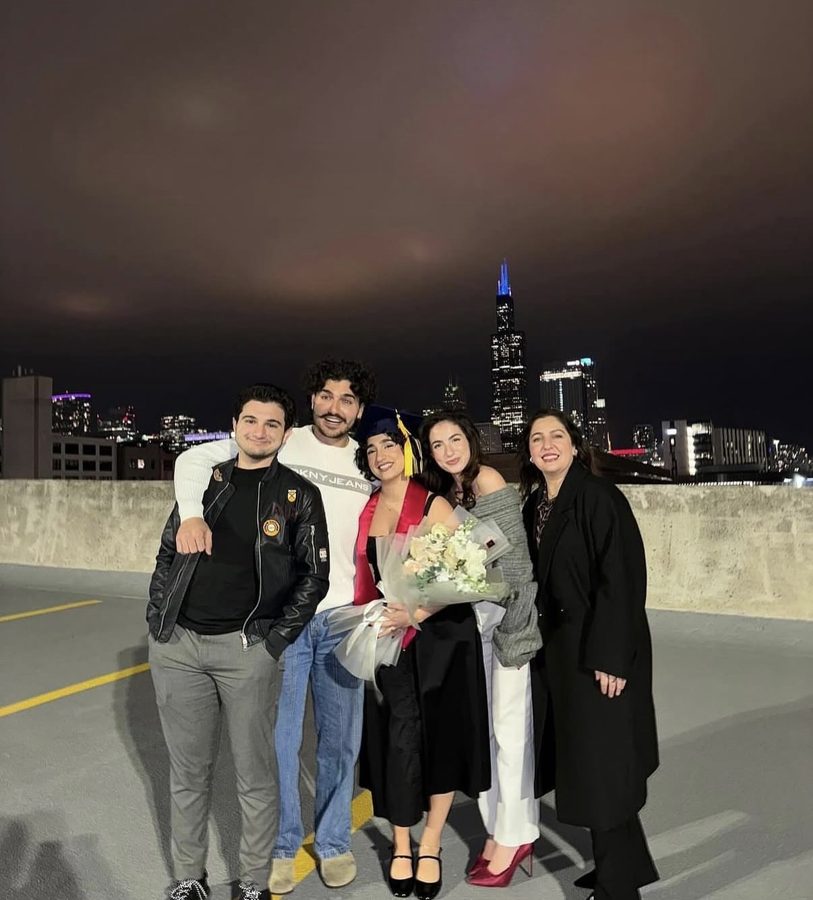 Abdul with a group on a rooftop, Chicago skyline behind